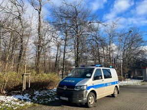 Zdjęcie przedstawia radiowóz na tle Stadionu Śląskiego